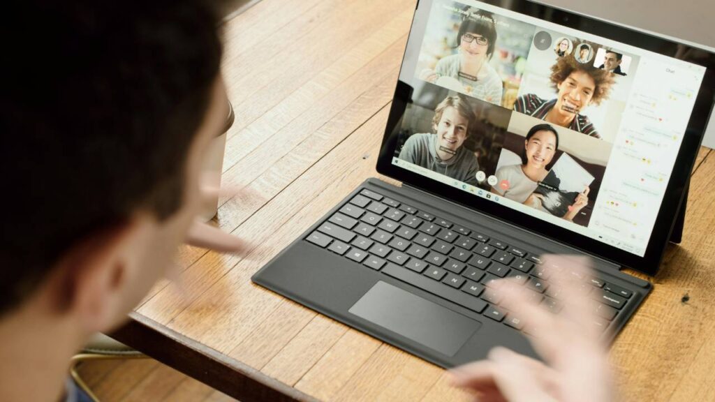 A man using his laptop for a video conference