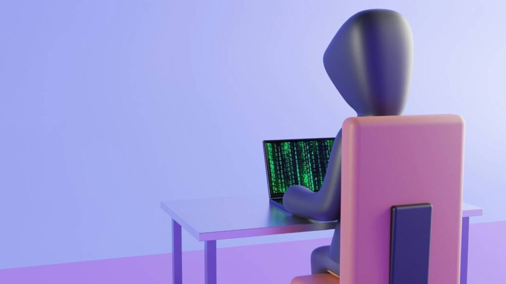 A figurine of a hacker using a laptop