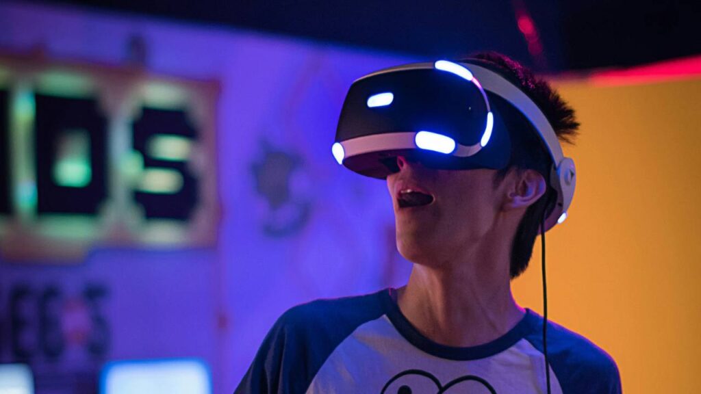 A man with open mouth using a VR headset