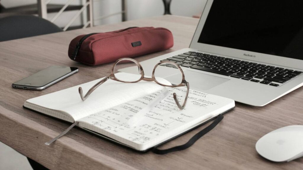 A pair of glasses placed on a notebook