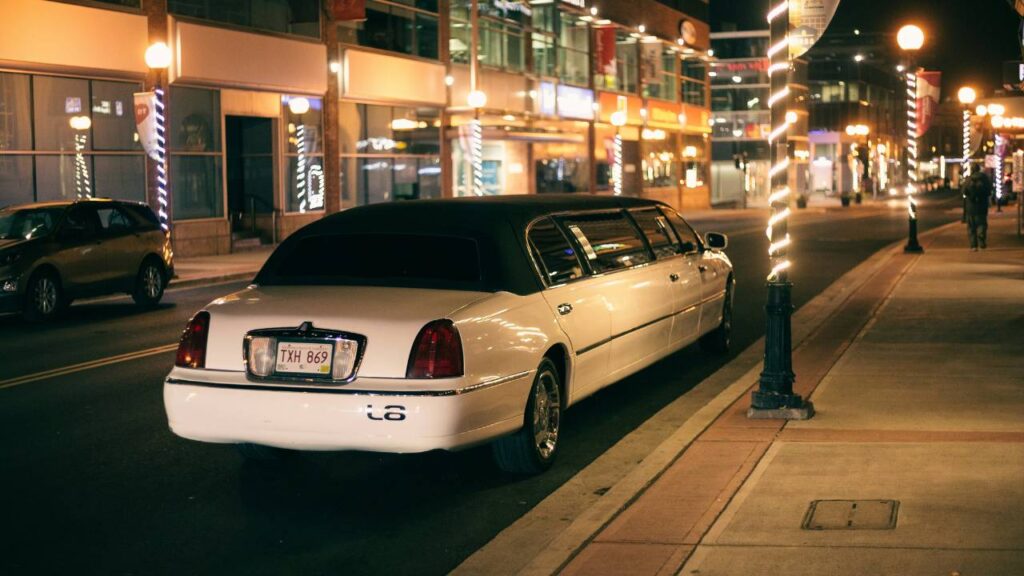 A white limousine parked in the street