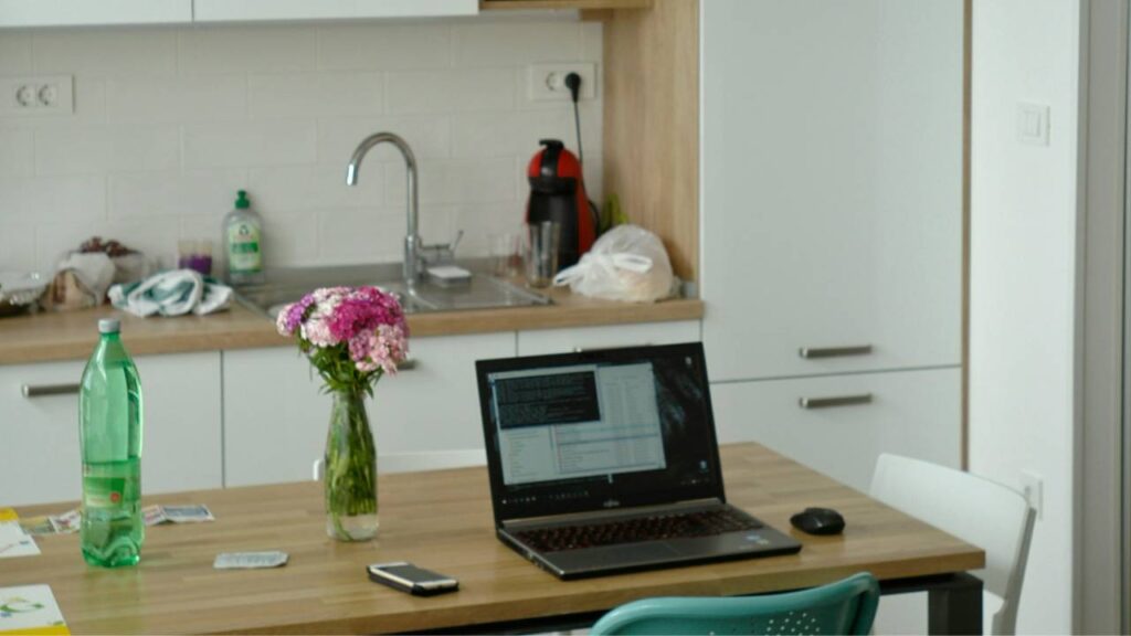 A laptop on a table in the office kitchen