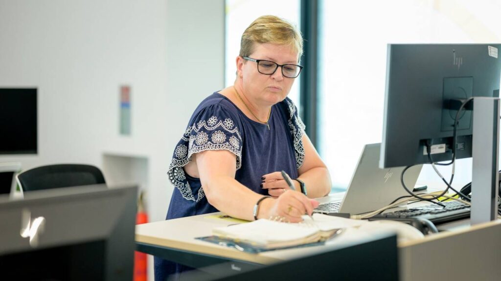 A middle-aged female employee working in an office