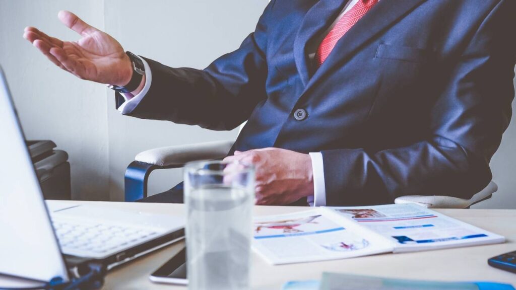 A boss wearing a suit talking in his office