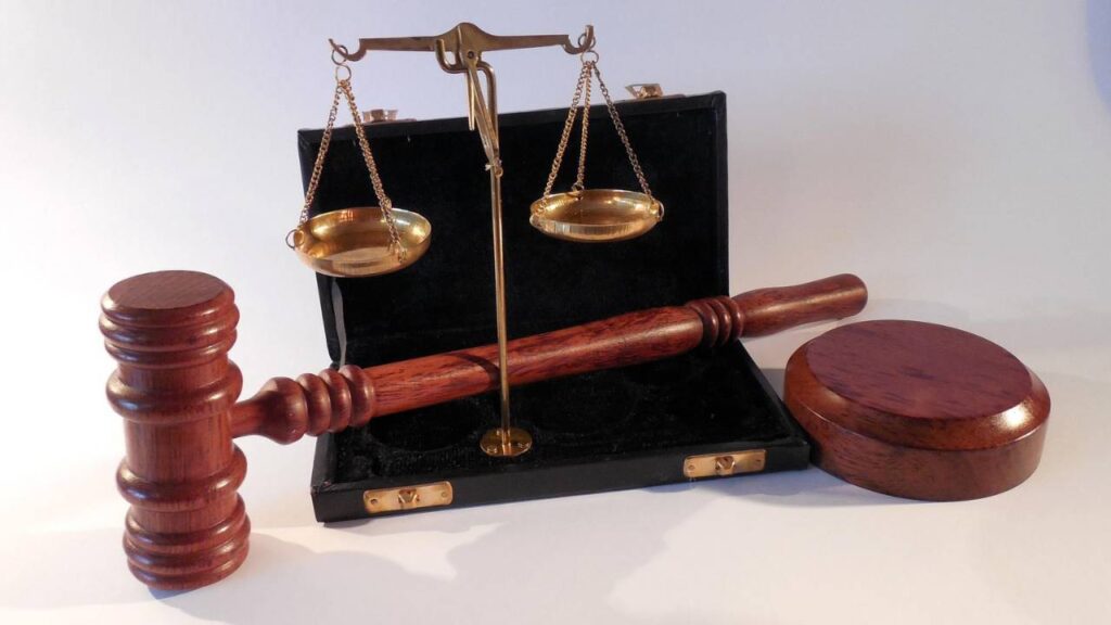 A gavel and scales in a small box