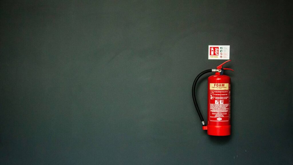 A photo of a fire extinguisher mounted on a wall 