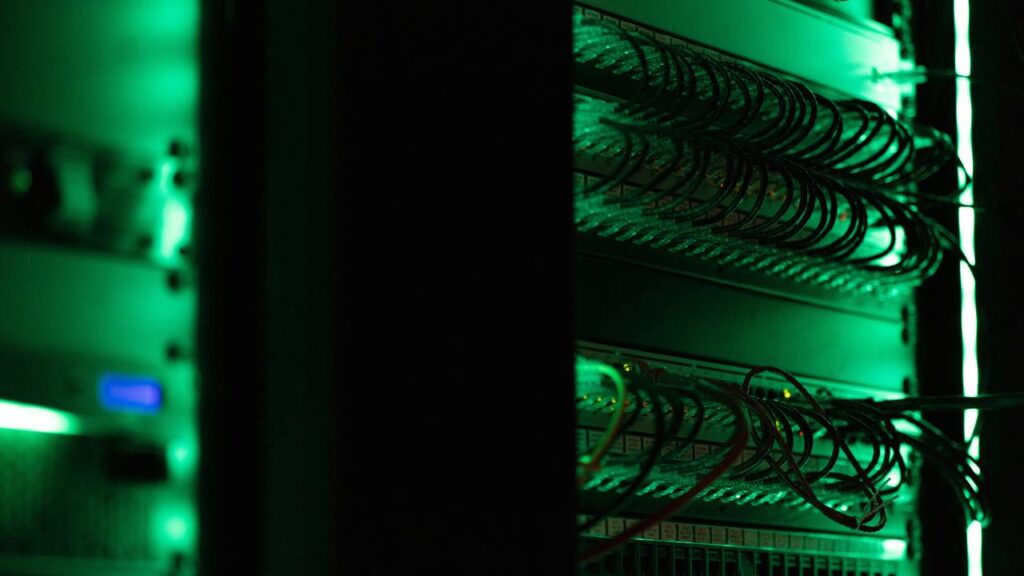 A close-up photo of a server computer with green lights
