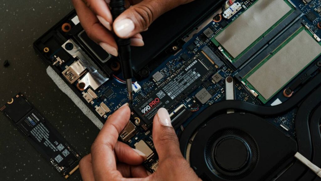 A close up photo of a woman inspecting a modern motherboard